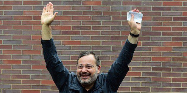 Al-Jazeera journalist Ahmed Mansour waves after his release in front of the prison, where he was being held in custody, on June 22, 2015. German authorities ordered the release of Al-Jazeera journalist Ahmed Mansour, two days after detaining him at the request of his native Egypt in a move that sparked outrage from rights groups.AFP PHOTO / JOHN MACDOUGALL (Photo credit should read JOHN MACDOUGALL/AFP/Getty Images)