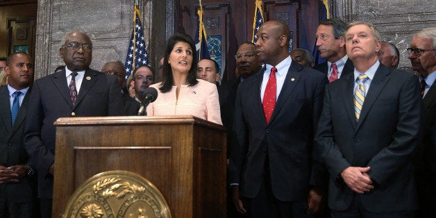 COLUMBIA, SC - JUNE 22: South Carolina Gov. Nikki Haley along with Sen. Lindsey Graham (R-SC) (R) and other lawmakers and activists delivers a statement to the media asking that the Confederate flag be removed from the state capitol ground on June 22, 2015 in Columbia, South Carolina. Debate over the flag flying on the capitol grounds was kicked off after nine people were shot and killed during a prayer meeting at the Emanuel African Methodist Episcopal Church in Charleston, South Carolina. (Photo by Joe Raedle/Getty Images)