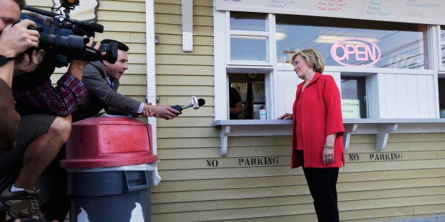 Democratic presidential candidate Hillary Rodham Clinton listens to a reporter's question as she waits for her ice cream at Dairy Twirl, Friday, July 3, 2015, in Lebanon, N.H. (AP Photo/Elise Amendola)