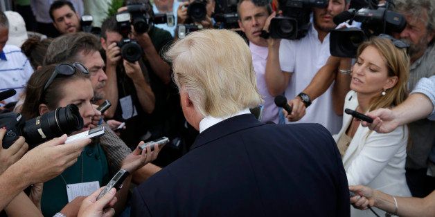 Republican presidential candidate Donald Trump talks to reporters as he arrives to a fund raising event at a golf course in the Bronx borough of New York, Monday, July 6, 2015. (AP Photo/Seth Wenig)