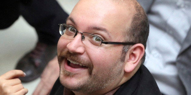 FILE - In this photo April 11, 2013 file photo, Jason Rezaian, an Iranian-American correspondent for The Washington Post, smiles as he attends a presidential campaign of President Hassan Rouhani in Tehran, Iran. Iran's official IRNA news agency says the detained Washington Post correspondent is back in court on Monday, June 8, 2015 for the second closed-door hearing in his espionage trial.(AP Photo/Vahid Salemi, File)