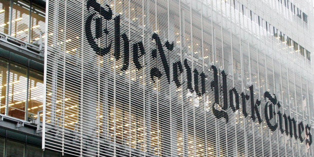 People pass the New York Times building in New York, Wednesday, Oct. 10, 2012. The New York Times Co.'s stock rose on Thursd