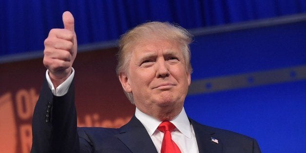 Real estate tycoon Donald Trump flashes the thumbs-up as he arrives on stage for the start of the prime time Republican presidential debate on August 6, 2015 at the Quicken Loans Arena in Cleveland, Ohio. AFP PHOTO/MANDEL NGAN (Photo credit should read MANDEL NGAN/AFP/Getty Images)