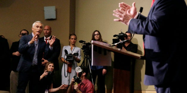 Miami-based Univision anchor Jorge Ramos, left, asks Republican presidential candidate Donald Trump a question about his immigration proposal during a news conference, Tuesday, Aug. 25, 2015, in Dubuque, Iowa. Ramos was later removed from the room. (AP Photo/Charlie Neibergall)