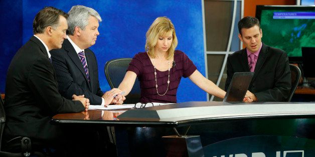 WDBJ-TV7 news morning anchor Kimberly McBroom, second from right, and meteorologist Leo Hirsbrunner, right, are joined by visiting anchor Steve Grant, second from left, and Dr. Thomas Milam, of the Carilion Clinic, as they observe a moment of silence during the early morning newscast at the station, in Roanoke, Va., Thursday, Aug. 27, 2015. The moment of silence was at the moment reporter Alison Parker and cameraman Adam Ward were killed during a live broadcast Wednesday, while on assignment in Moneta. (AP Photo/Steve Helber)