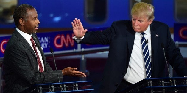 Republican presidential hopefuls Ben Carson and Donald Trump participate in the Republican Presidential Debate at the Ronald Reagan Presidential Library in Simi Valley, California on September 16, 2015. Republican presidential frontrunner Donald Trump stepped into a campaign hornet's nest as his rivals collectively turned their sights on the billionaire in the party's second debate of the 2015. AFP PHOTO / FREDERIC J. BROWN (Photo credit should read FREDERIC J. BROWN/AFP/Getty Images)