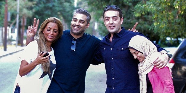 ==EGYPT OUT==
Canadian Al-Jazeera journalist Mohamed Fahmy (2L) and his colleague Baher Mohamed (2R) celebrate with their wi