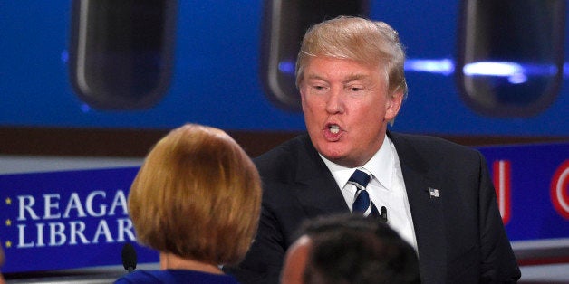 Republican presidential candidate, businessman Donald Trump, top, talks with Carly Fiorina following the CNN Republican presidential debate at the Ronald Reagan Presidential Library and Museum on Wednesday, Sept. 16, 2015, in Simi Valley, Calif. (AP Photo/Mark J. Terrill)