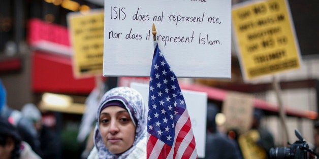 A Muslim woman holds a poster during a protest against Donald Trump on December 20, 2015 in New York. Republican presidential hopeful Donald Trump proposed a call for a ban on Muslims entering the United States. AFP PHOTO/KENA BETANCUR / AFP / KENA BETANCUR (Photo credit should read KENA BETANCUR/AFP/Getty Images)