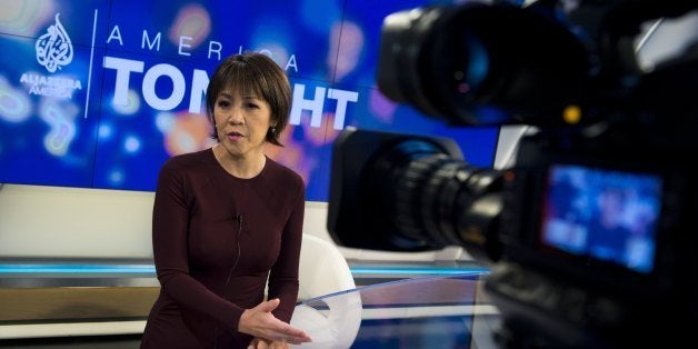 Joie Chen, host of the new Al Jazeera America nightly news program America Tonight, sits at the anchor desk in the network's