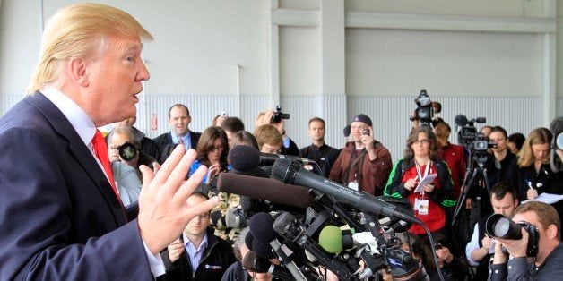 Donald Trump, a possible 2012 presidential candidate, talks to reporters after arriving at the Pease International Tradeport Wednesday, April 27, 2011 in Portsmouth, N.H. Trump said he was "very proud" to have forced the White House's decision to release President Barack Obama's birth certificate. (AP Photo/Jim Cole)