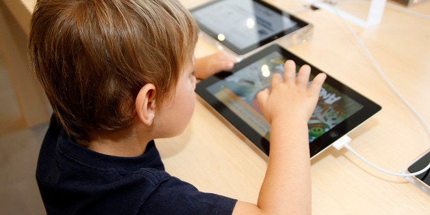 BARCELONA, SPAIN - JULY 28: A child plays with an iPad at the opening of Apple's New Barcelona Store in Passeig de Gracia on