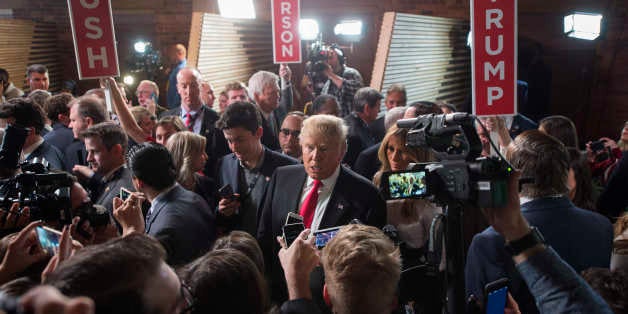 Republican presidential candidate Donald Trump talks with reporters in the Spin Room following the CBS News Republican Presid