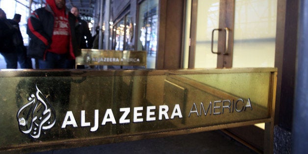 NEW YORK, NY - JANUARY 13: People walk into the offices of Al Jazeera America, a cable news channel that debuted in August 2