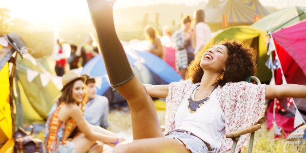 Carefree woman outside tents at music festival