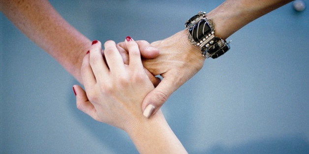 Close-up of women holding hands