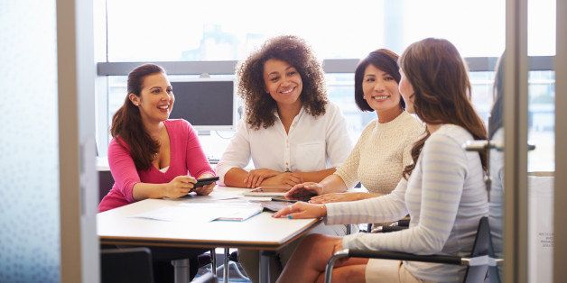 Casually dressed female colleagues talking in a meeting room