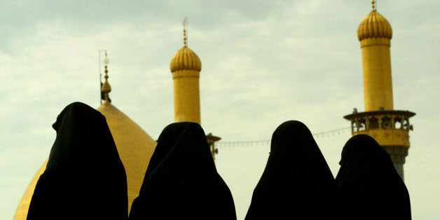 Iraqi Shi'ite women stand by the holy Mosque of Abbas in the center ofKerbala April 22, 2003. Countless thousands of Iraqi Shi'ite Muslims,oppressed under Saddam Hussein, thronged the holy city of Kerbala onTuesday, free for the first time in decades to mark one the most sacredmoments of their year. REUTERS/Yannis BehrakisYB/WS