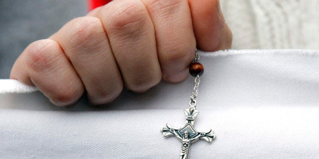 A Christian fundamentalist holds a crucifix during a protest against the play "Golgota Picnic" by Argentina-born director Rodrigo Garcia in Paris December 11, 2011. The fundamentalists protested against the play as they considered it offensive to their religion. REUTERS/Benoit Tessier (FRANCE - Tags: RELIGION CIVIL UNREST)