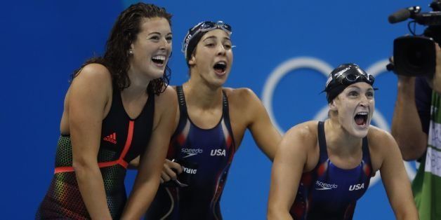 (FromL) USA's Allison Schmitt, USA's Madeline 'Maya' Dirado and USA's Leah Smith encourage their teammate USA's Katie Ledecky competing in the Women's 4x200m Freestyle Relay Final during the swimming event at the Rio 2016 Olympic Games at the Olympic Aquatics Stadium in Rio de Janeiro on August 10, 2016. / AFP / Odd Andersen (Photo credit should read ODD ANDERSEN/AFP/Getty Images)