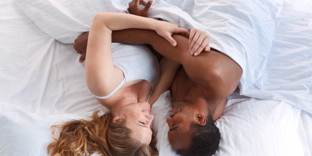 Overhead close up portrait of a young romantic couple hugging. Love and relationships lifestyle, interior bedroom.