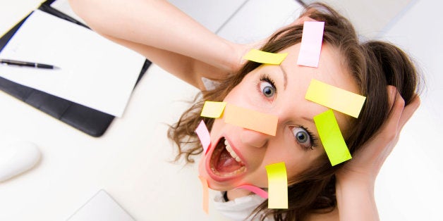 Overwhelmed office worker with many post-its on her face