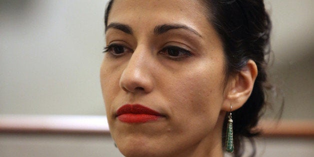 NEW YORK, NY - JULY 23: Huma Abedin, wife of Anthony Weiner, a leading candidate for New York City mayor, listens as her husband speaks at a press conference on July 23, 2013 in New York City. Weiner addressed news of new allegations that he engaged in lewd online conversations with a woman after he resigned from Congress for similar previous incidents. (Photo by John Moore/Getty Images)