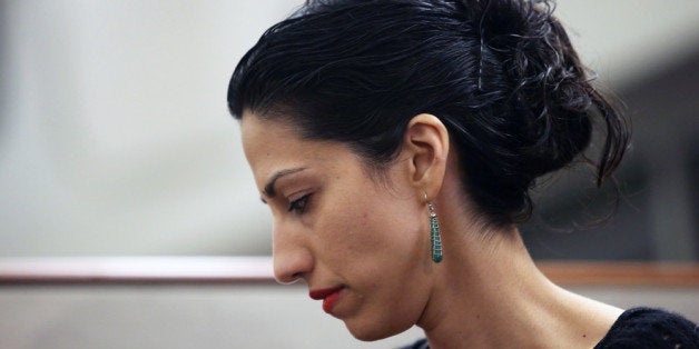 NEW YORK, NY - JULY 23: Huma Abedin, wife of Anthony Weiner, a leading candidate for New York City mayor, listens as her husband speaks at a press conference on July 23, 2013 in New York City. Weiner addressed news of new allegations that he engaged in lewd online conversations with a woman after he resigned from Congress for similar previous incidents. (Photo by John Moore/Getty Images)