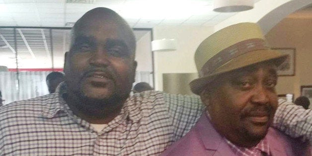 This undated photo provided by the Parks & Crump, LLC shows Terence Crutcher, left, with his father, Joey Crutcher. Crutcher, an unarmed black man was killed by a white Oklahoma officer Friday, Sept. 16, 2016, who was responding to a stalled vehicle. (Courtesy of Crutcher Family/Parks & Crump, LLC via AP)