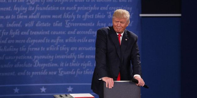 Donald Trump, 2016 Republican presidential nominee, reacts during the second U.S. presidential debate at Washington University in St. Louis, Missouri, U.S., on Sunday, Oct. 9, 2016. As has become tradition, the second debate will resemble a town hall meeting, with the candidates free to sit or roam the stage instead of standing behind podiums, while members of the audience -- uncommitted voters, screened by the Gallup Organization -- will ask half the questions. Photographer: Daniel Acker/Bloomberg via Getty Images