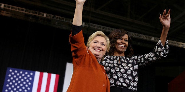 U.S. Democratic presidential candidate Hillary Clinton arrives to a campaign rally accompanied by U.S. first lady Michelle Ob