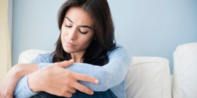 Sad woman sitting on sofa