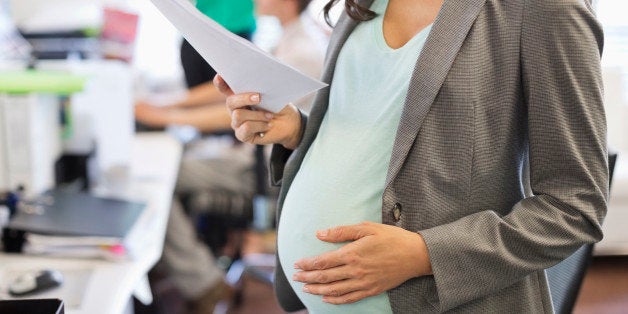 Pregnant businesswoman working in office