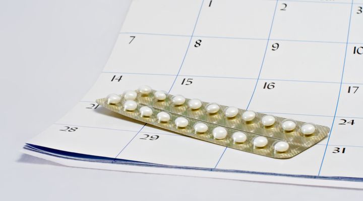 Birth control pills on a calendar