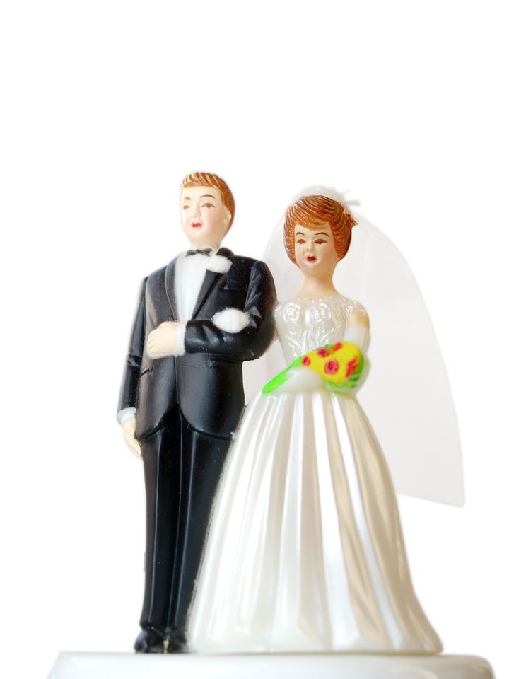 A wedding couple made of plastic, models for wedding cake, isolated on white background