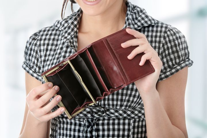 Young caucasian woman with empty wallet - broke