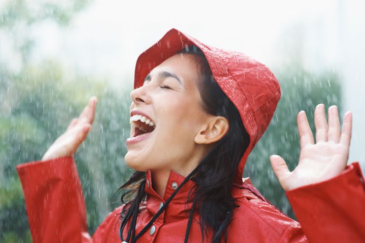 Pretty woman playing in the rain