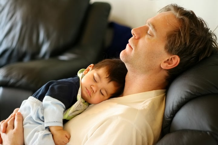 Baby sleeping on dad's chest