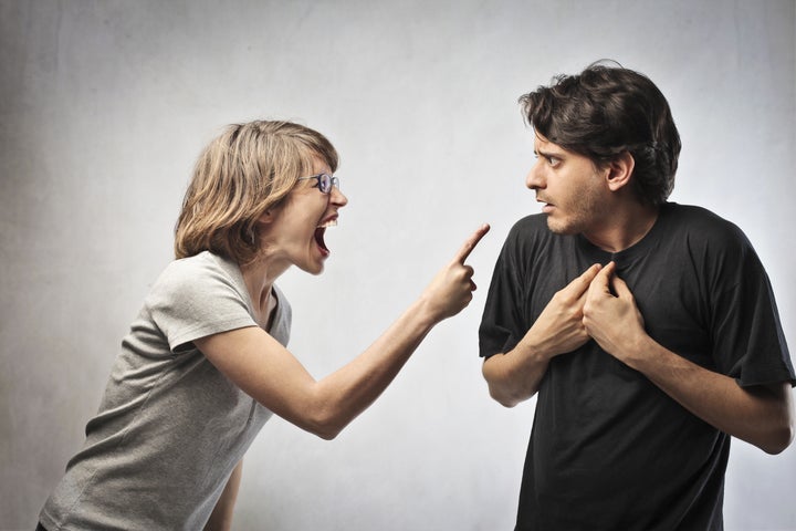 Angry woman pointing her finger against her husband