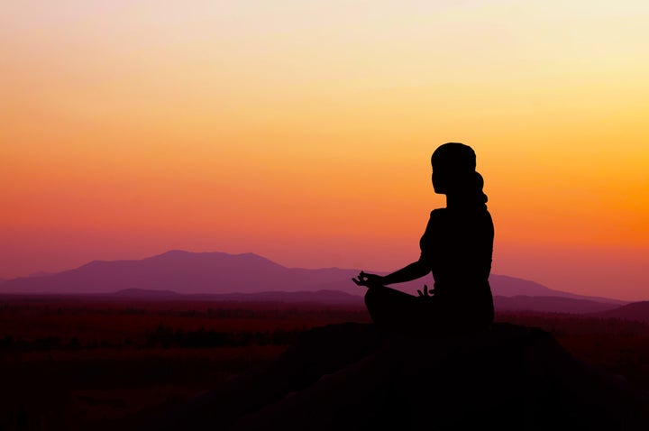 silhouette of a beautiful yoga...