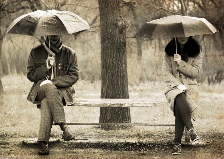 Two sitting at bench in rainy day. Photo in old image style.