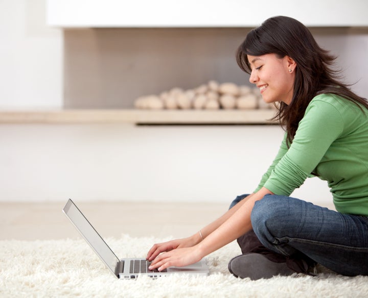 woman with a laptop working from home smiling