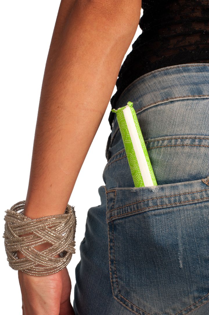 Menstruation concept, tampon out of a tight jeans pocket