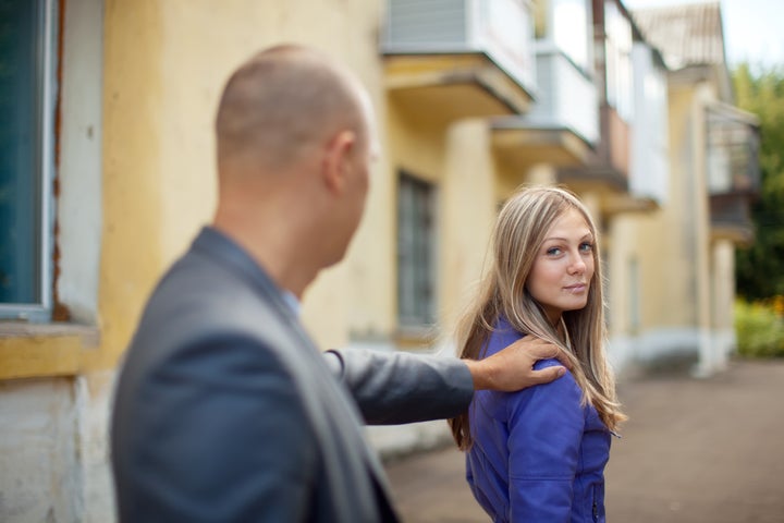 The man stops beautiful woman on city street