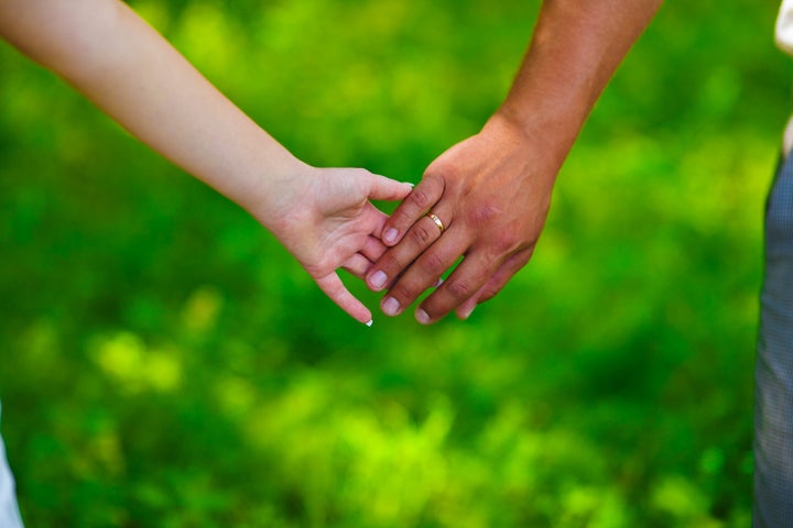 wedding couple holding hands on ...