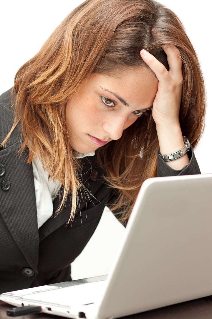 Stressed businesswoman working at her notebook