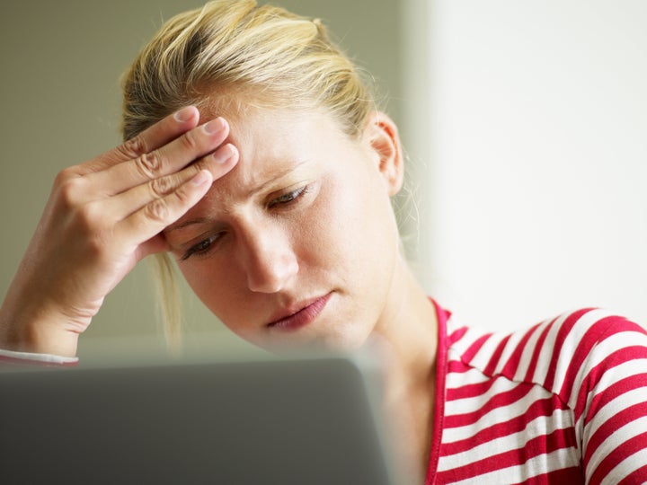 woman having headache with hands on temple. Copy space