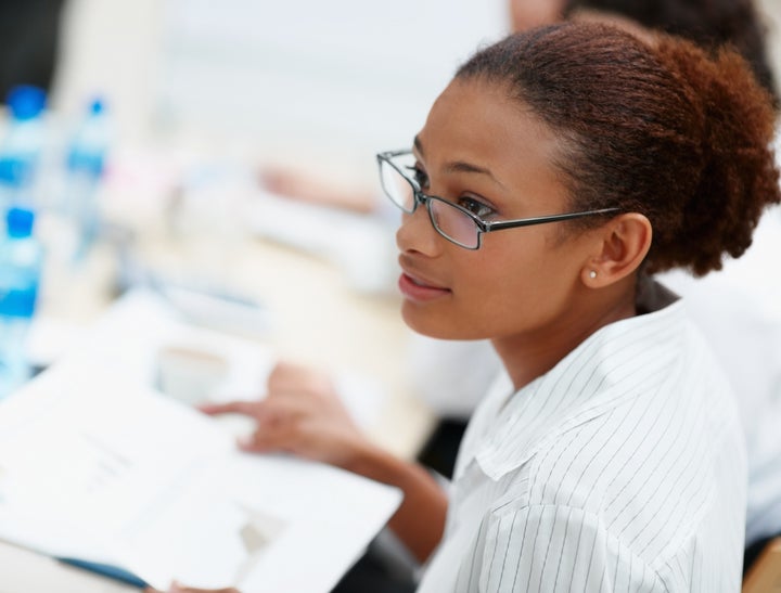 Young African American business woman with spectacles while at work