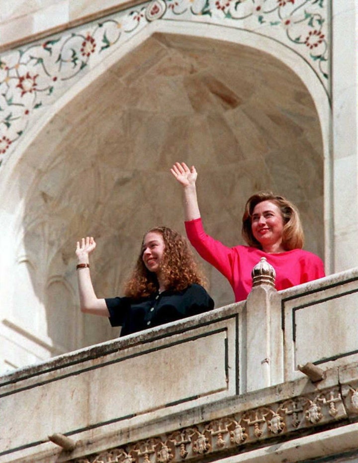 AGRA, INDIA - MARCH 30: US First Lady Hillary Clinton (R) and her daughter Chelsea wave from the terrace of the Taj Mahal in Agra, India, 30 March during a break in the First Lady's 12-day tour of South Asia. Clinton and her daughter spent 90 minutes at the white marble mausoleum built by Emperor Shah Jahan as a mark of undying love for his wife Mumtaz. AFP PHOTO (Photo credit should read DOUGLAS E. CURRAN/AFP/Getty Images)