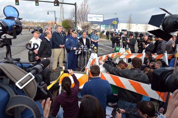 Colonel Timothy Albens (C, at microphone), Massachusetts State Police, with Massachusetts Governor Deval Patrick (R) and Boston Police Commissioner Ed Davis (L) speaks to the media at a shopping mall on the perimeter of a locked down area as a search for the second of two suspects wanted in the Boston Marathon bombings takes place April 19, 2013 in Watertown, Massachusetts. AFP PHOTO/Stan HONDA (Photo credit should read STAN HONDA/AFP/Getty Images)